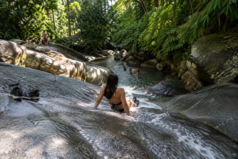 Guided river and waterslide category card, showing visitors on a natural rock waterslide day trip near El Yunque, one of eight waterslides-river tours compared on this page.