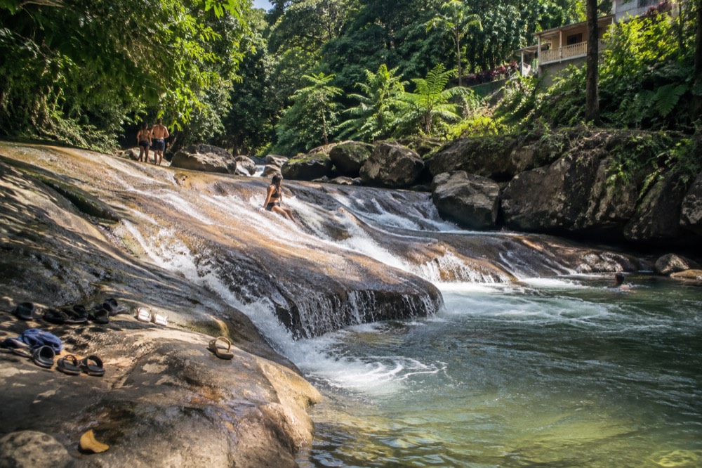 Smooth rock ledges and moving water in a forested stream bed