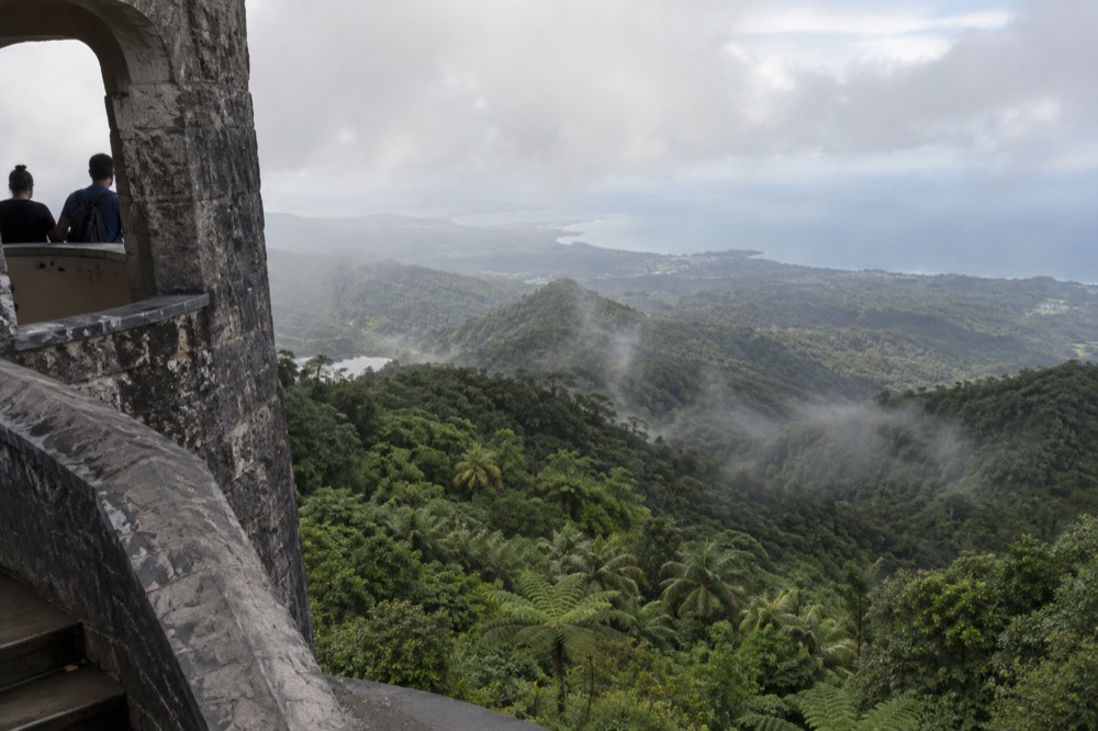 Empty stone observation tower overlooking rainforest ridges to the coast